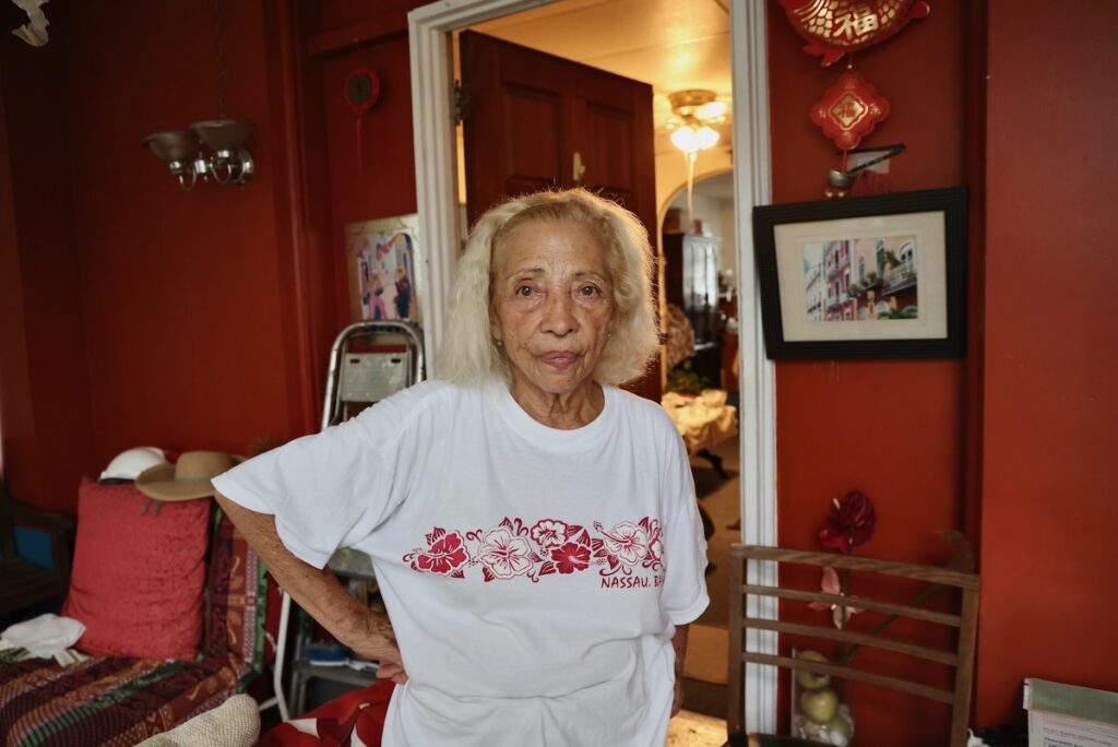 Blanca Maldonado stands on the porch of her home