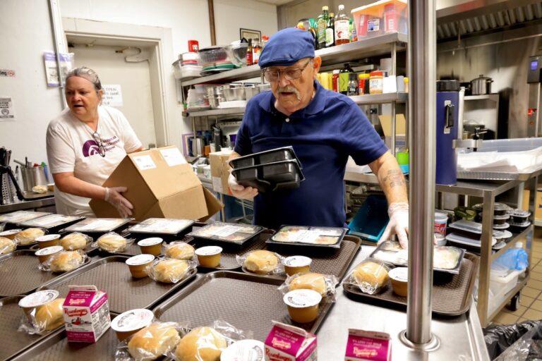 Helen Burke (left) and Thomas Homer (right) prepare lunches