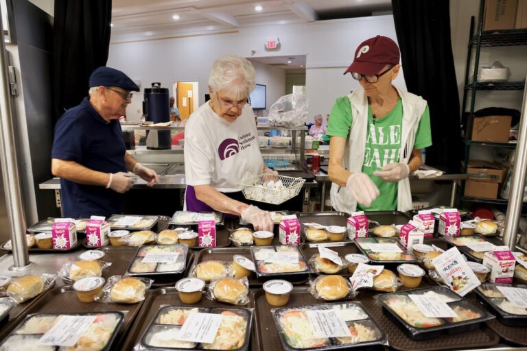Volunteering preparing lunch trays at Lutheran Settlement House