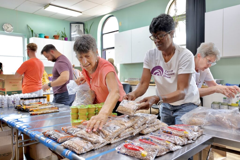 2025 08 14-e lee-starling martin-philadelphia lutheran settlement house-thursday food pantry presentation Food pantry volunteers organize food giveaway tables at Lutheran Settlement House