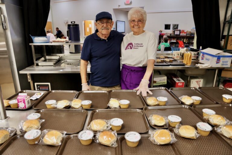 Thomas Homer (left) and Marge Wible (right) volunteering at Lutheran Settlement House