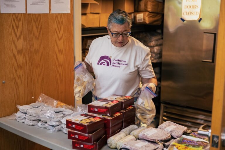 Maria Tanczak sorts and stocks the frozen foods table