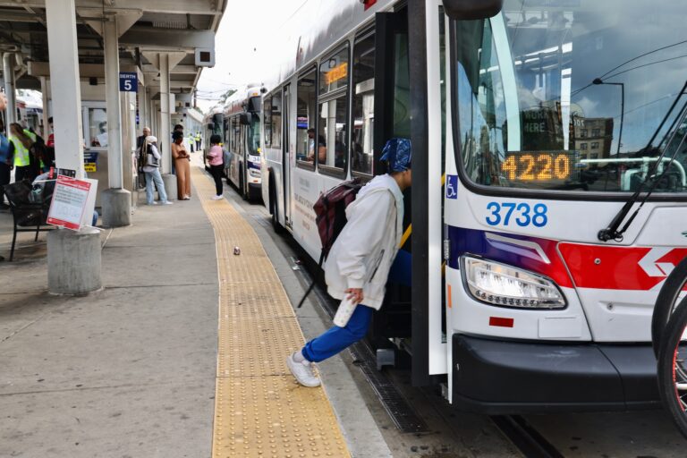 A woman steps onto a bus