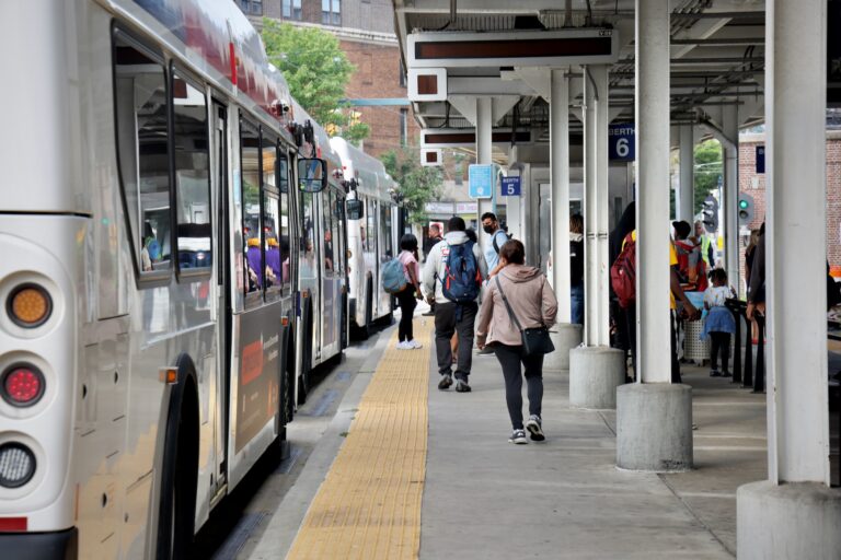 A crowded bus terminal, with numerous buses lined up back to back
