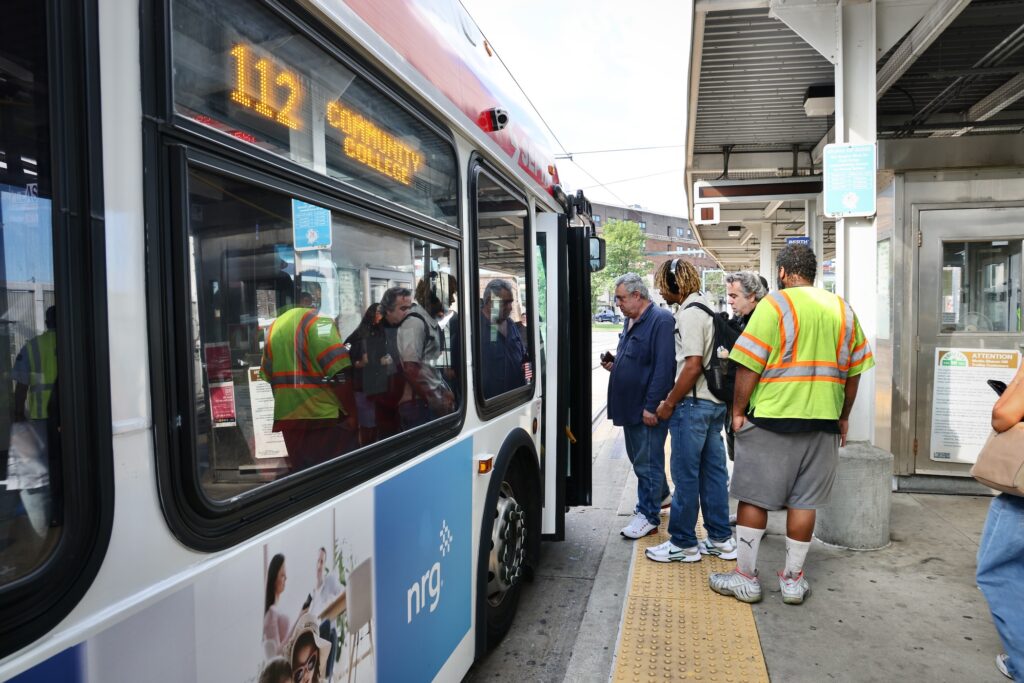 People lining up to board a bus
