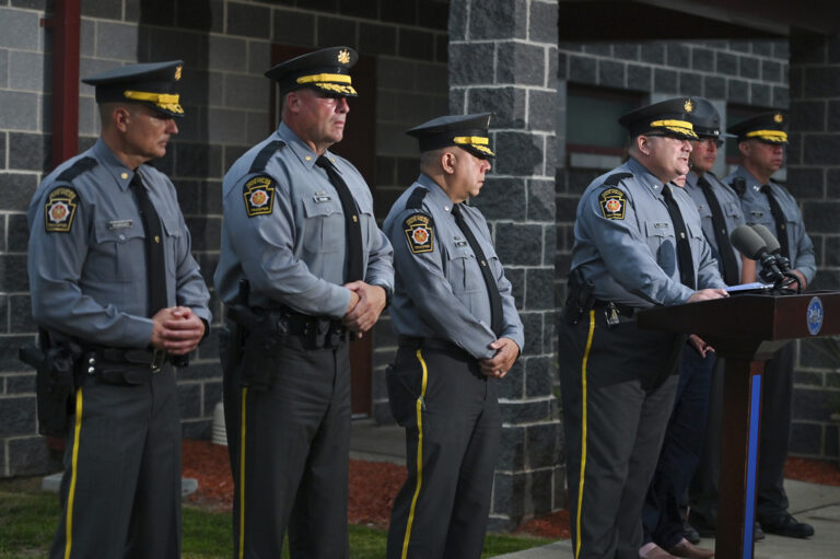 Pennsylvania State Troopers stand in line during a press conference