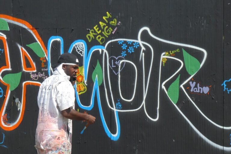 a person makes art on the art wall