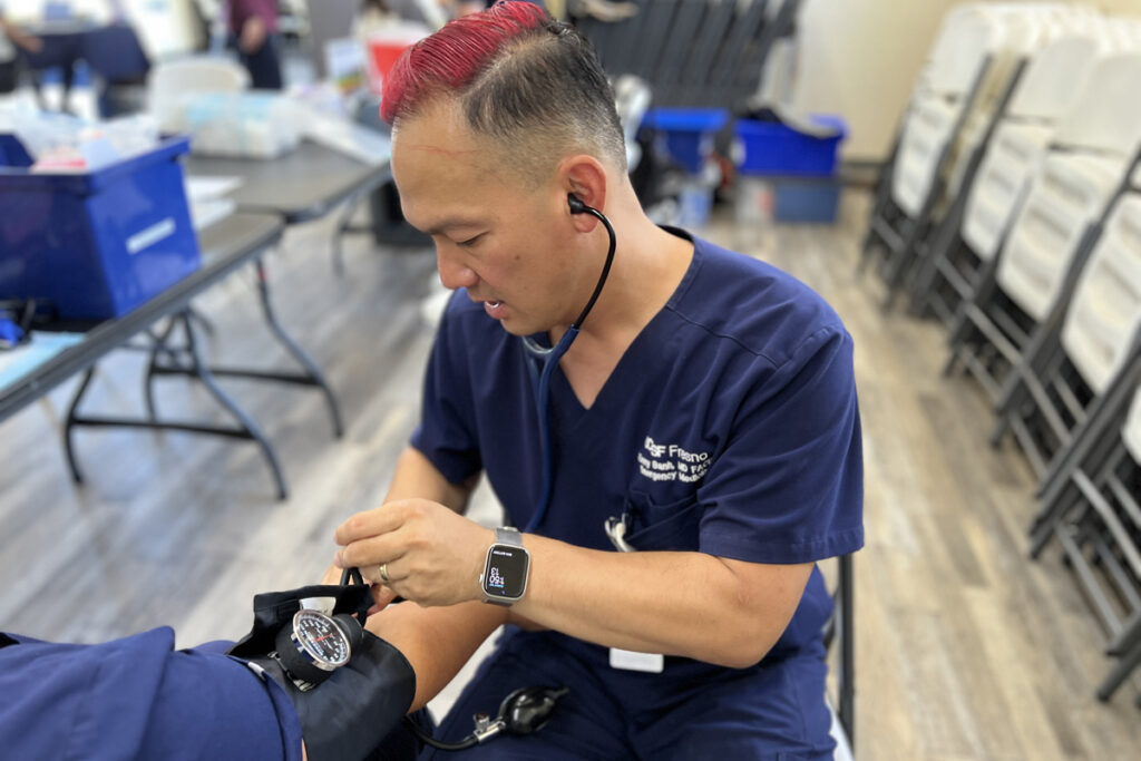 Mobile HeaL_1200 Emergency medicine physician Kenny Banh measures a patient’s blood pressure. (Courtesy of UCSF Fresno)