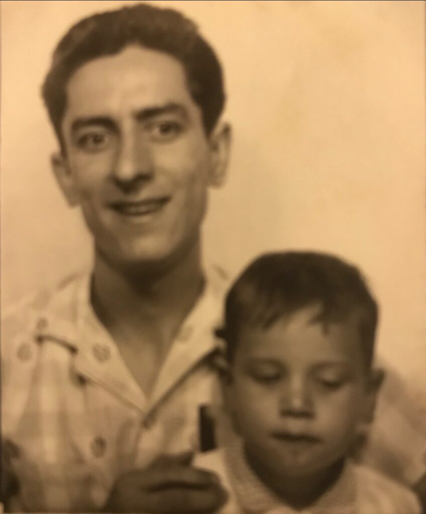 An old photo of a man posing with a young boy