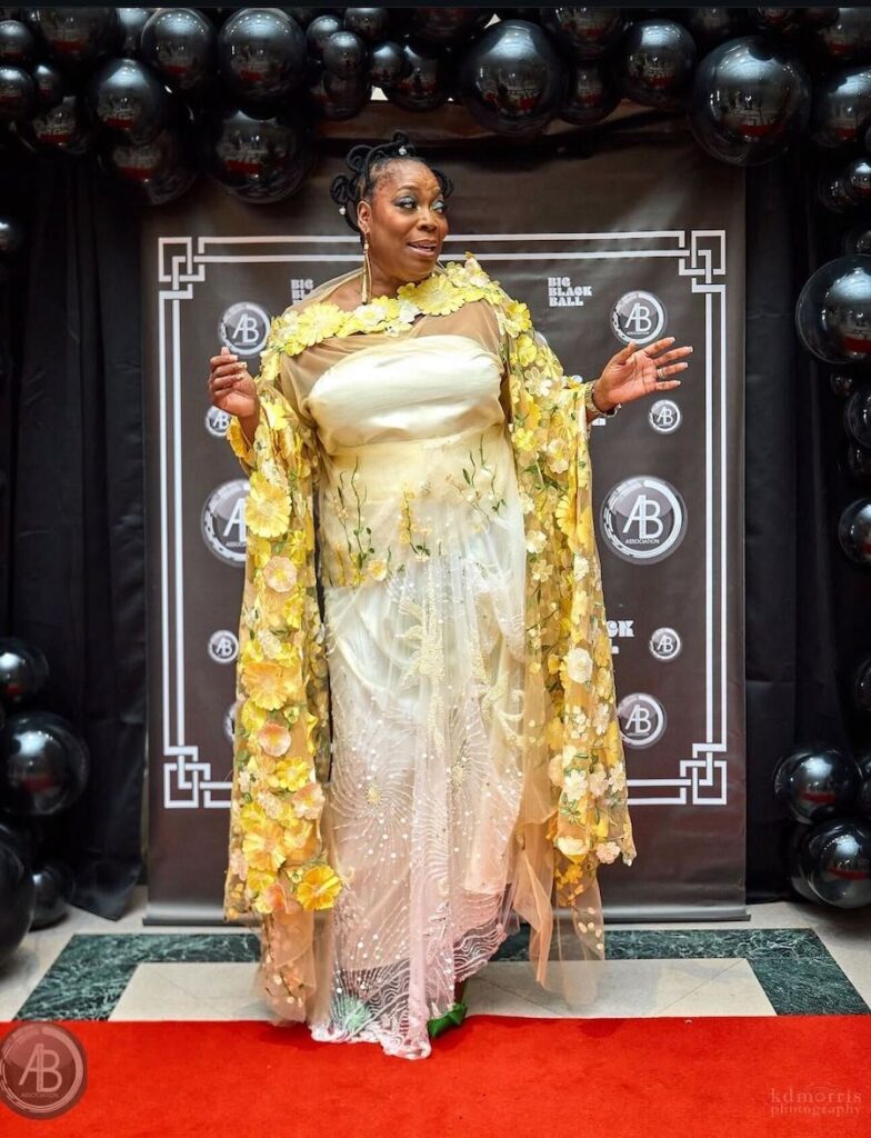 A woman wears a fancy dress on a red carpet event