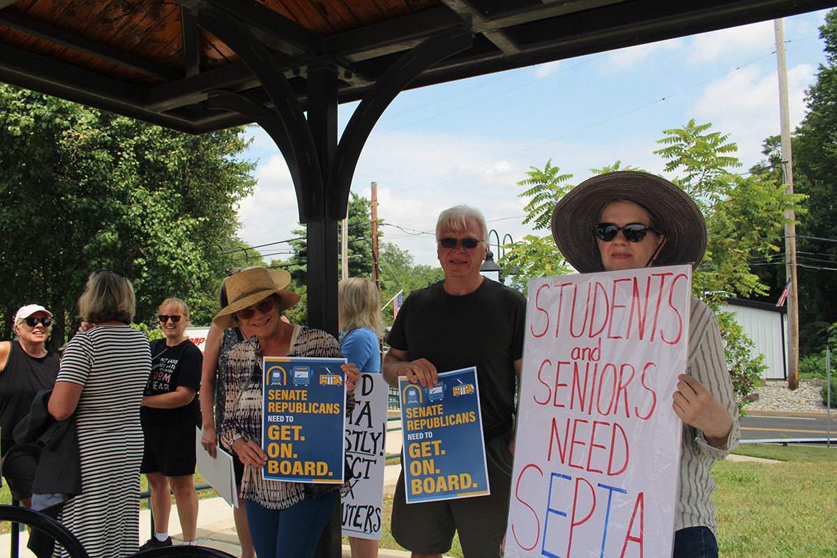 Bucks County residents hold signs at a SEPTA funding rally