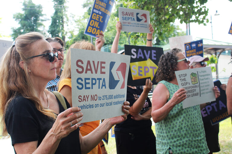 Bucks County residents hold signs at a SEPTA funding rally