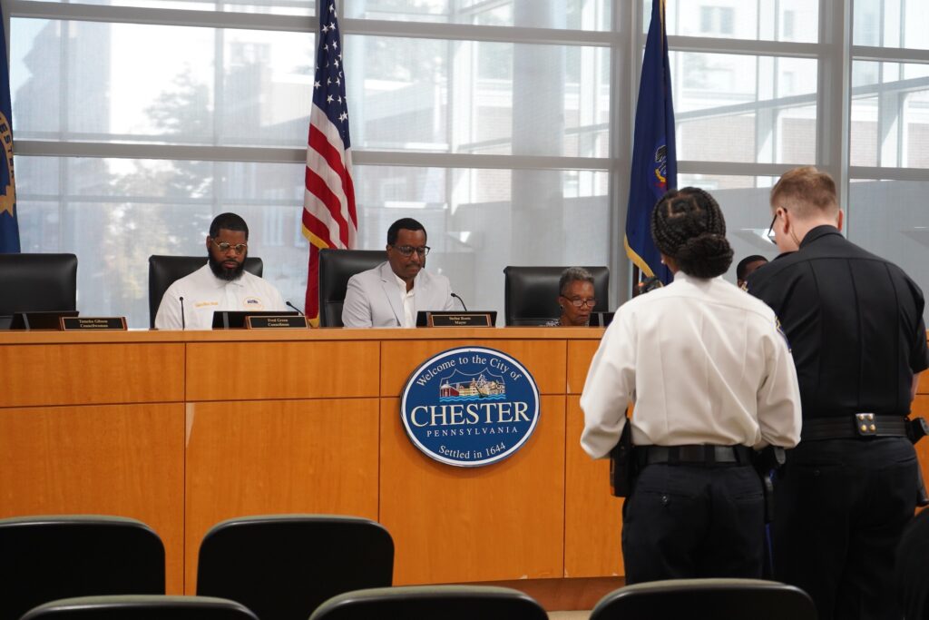 Council members seated during a hearing