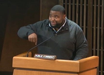 Coby Owens speaking at a podium