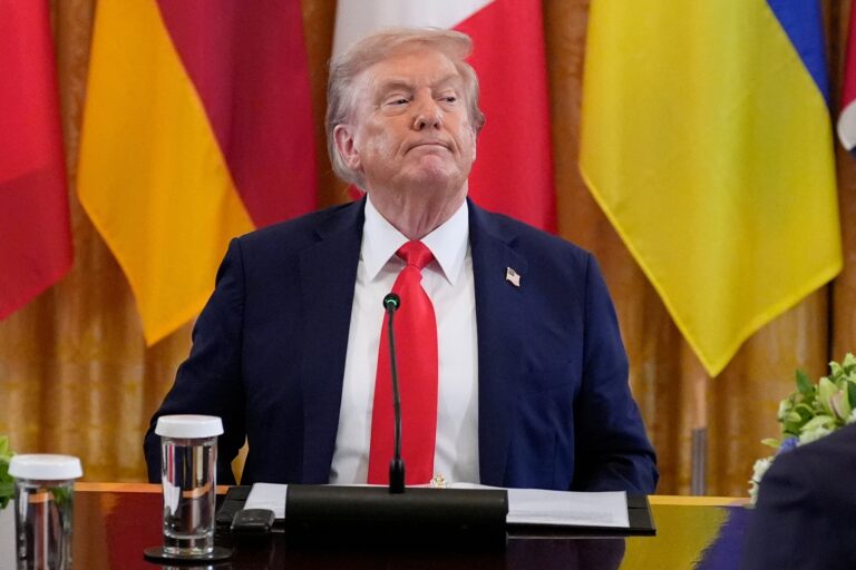Donald Trump looks on