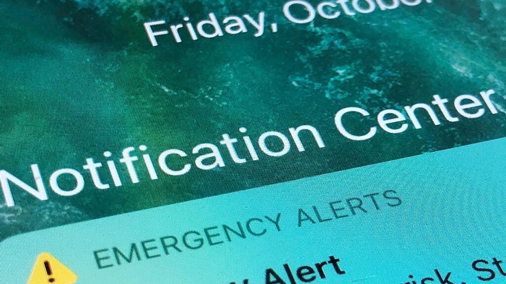 An emergency alert is displayed on a cellphone
