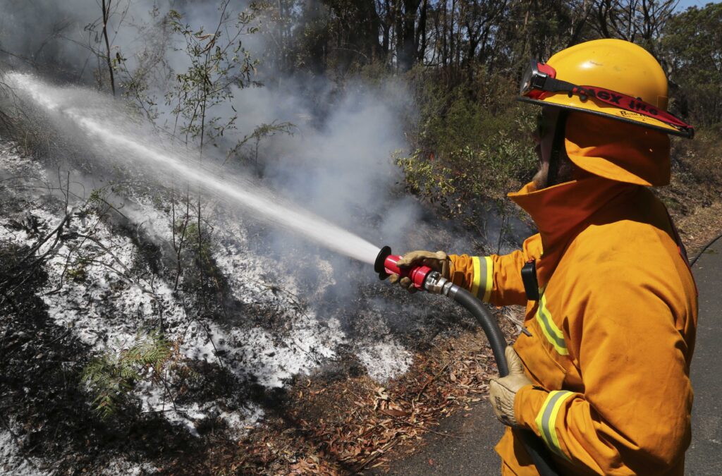 firefighting-foam-los-angelos-file-2022-ap-2 A firefighter sprays foam on smoldering bush