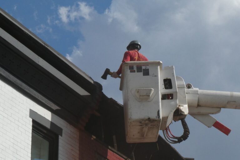 a worker attends to a collapsed Philadelphia house