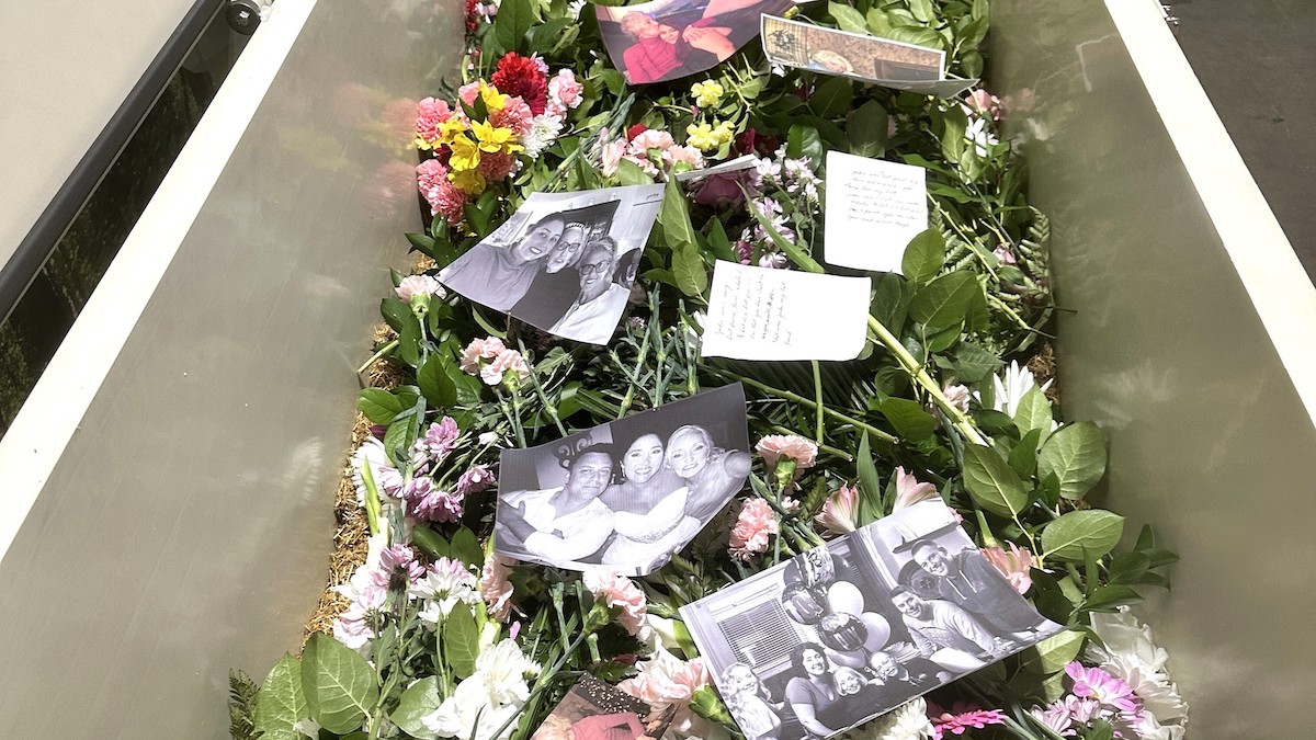 Flowers, pictures and notes inside Jacqueline Reis Messina's vessel before the composting process