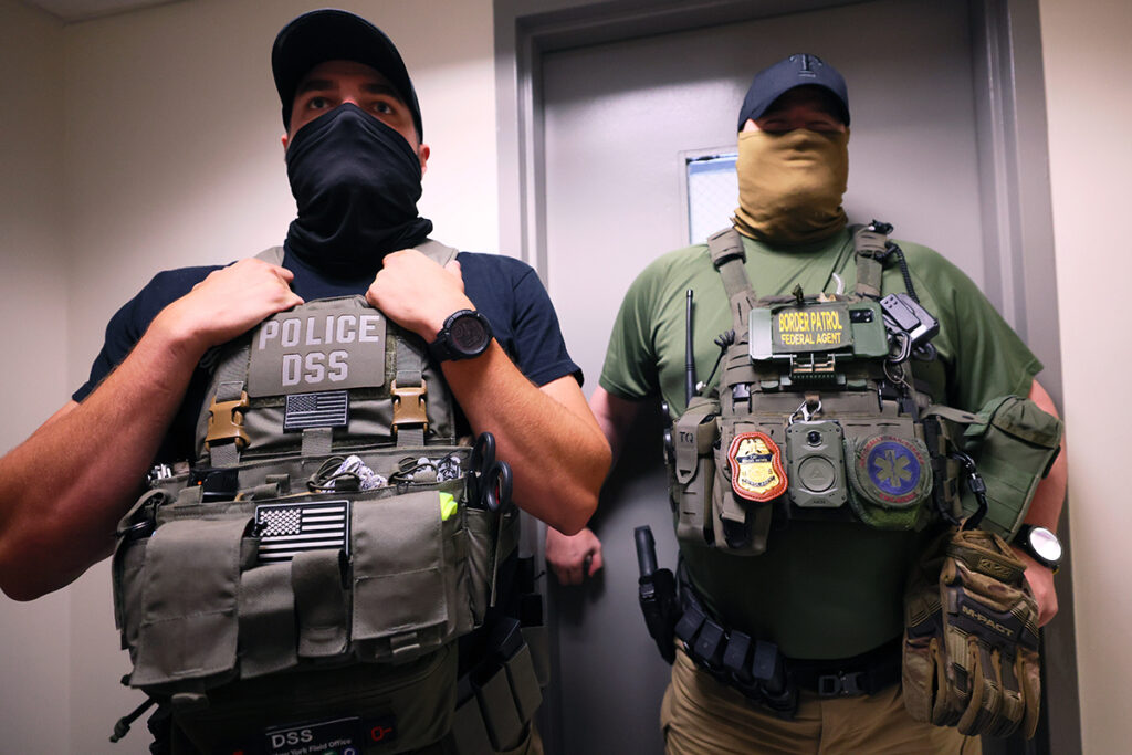 Immigration enforcement officials stand inside a criminal courthouse in New York City.
