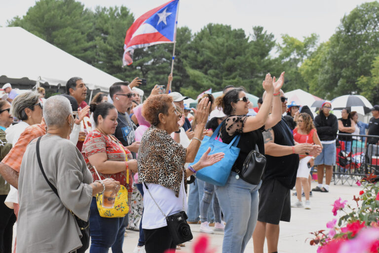 People cheer in a crowd at Mercer County's Fiesta Latina
