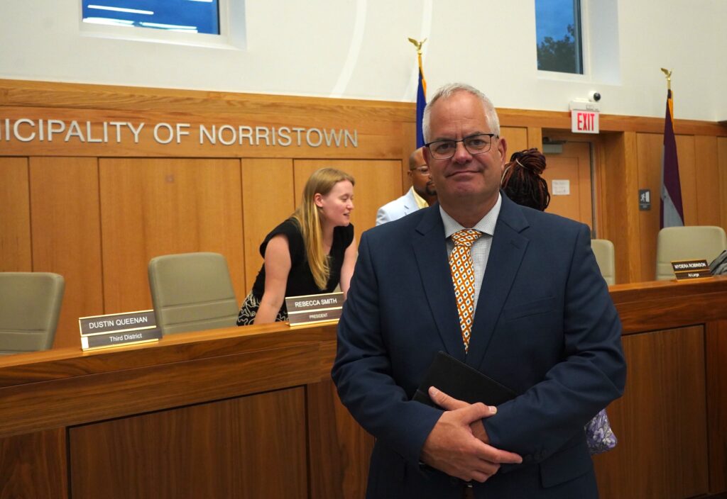 Michael Trail poses for a photo in the council chambers