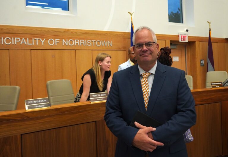 Michael Trail poses for a photo in the council chambers