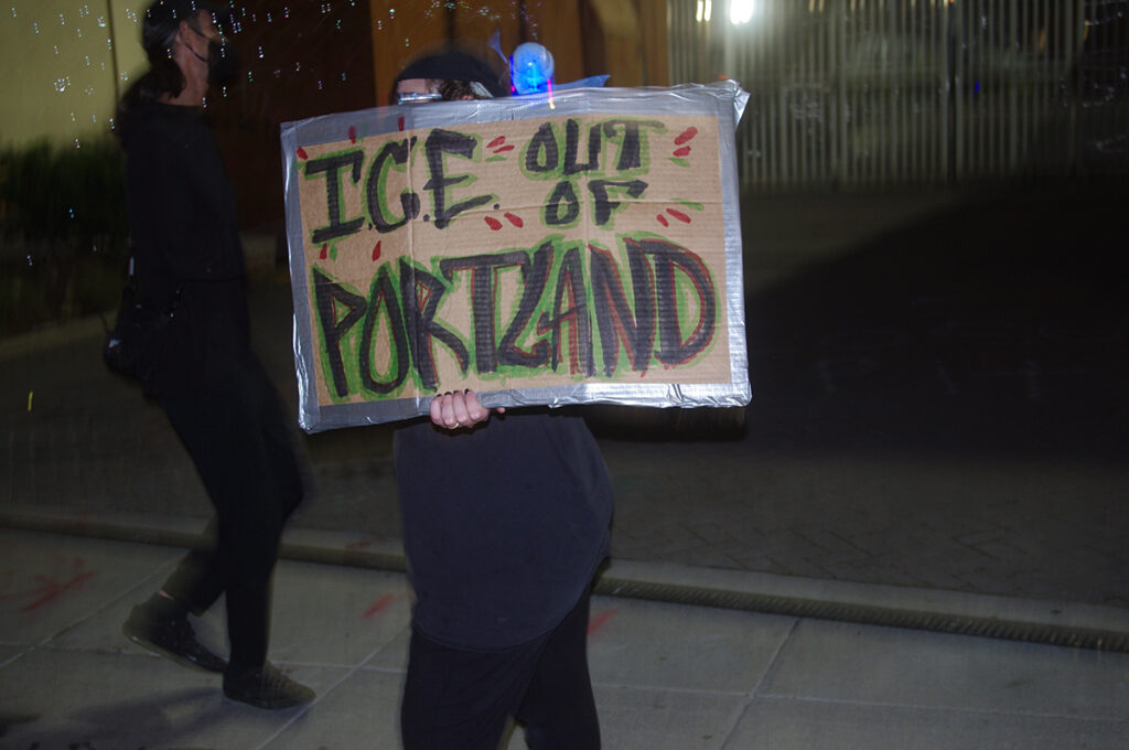 A man holds up a sign that reads 