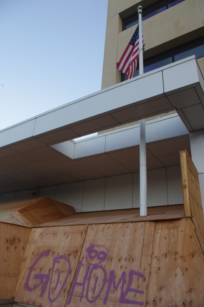 Protective plywood covers the doors and windows of the U.S. Immigration and Customs Enforcement facility in Portland, Oregon