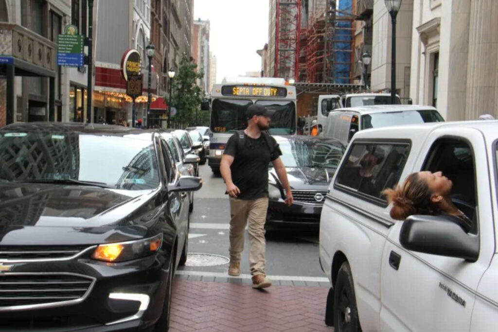 pedestrian-philadelphia-file-el a person walks through traffic in Center City Philadelphia