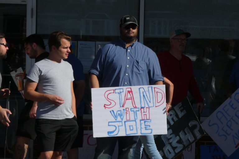 a sign reads STAND WITH JOE