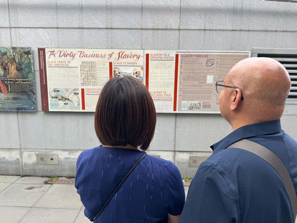 Visitors view one of the exhibits which is part of the President’s House Site at Independence Park