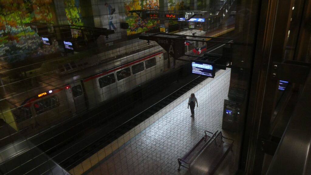 a person walks through a SEPTA Regional Rail station