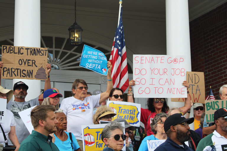 rallygoers in North Wales hold signs about SEPTA finding