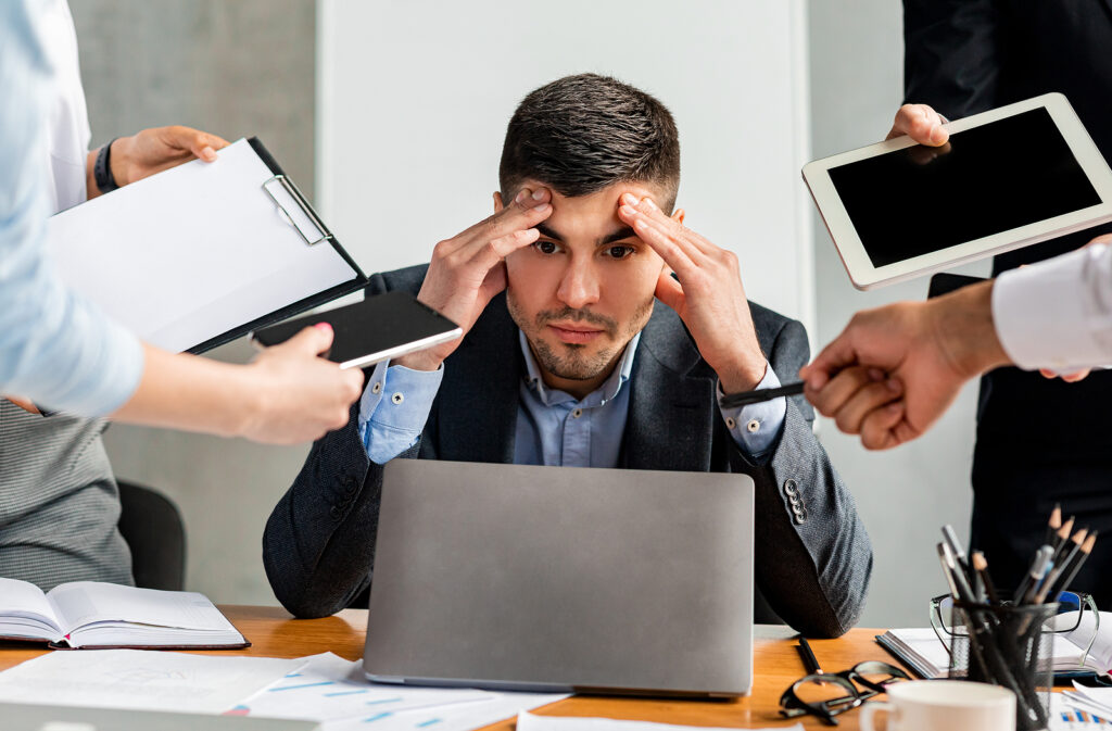Multitasking. Stressed Businessman At Laptop Touching Head Tired Constant pressure to be more productive — especially at work — can cause declining performance and even burnout. That's led some thinkers in the field to push for an updated idea of what true productivity should look like. (Bigstock/Prostock-studio)