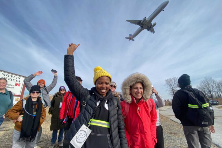 Walk Around Philadelphia participants watching a plane overhead