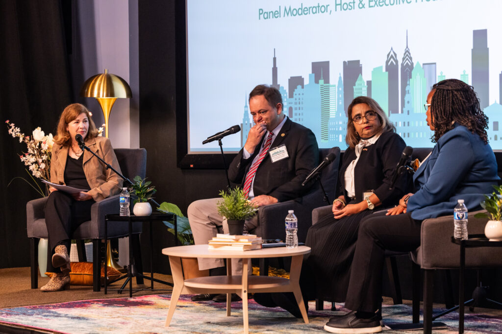 09 18 2025 k paynter exploring trends immigration event-10 Four people sitting on stage for the panel discussion