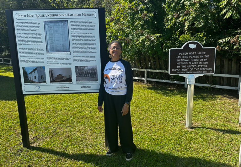Linda Shockley smiles outside the Peter Mott House