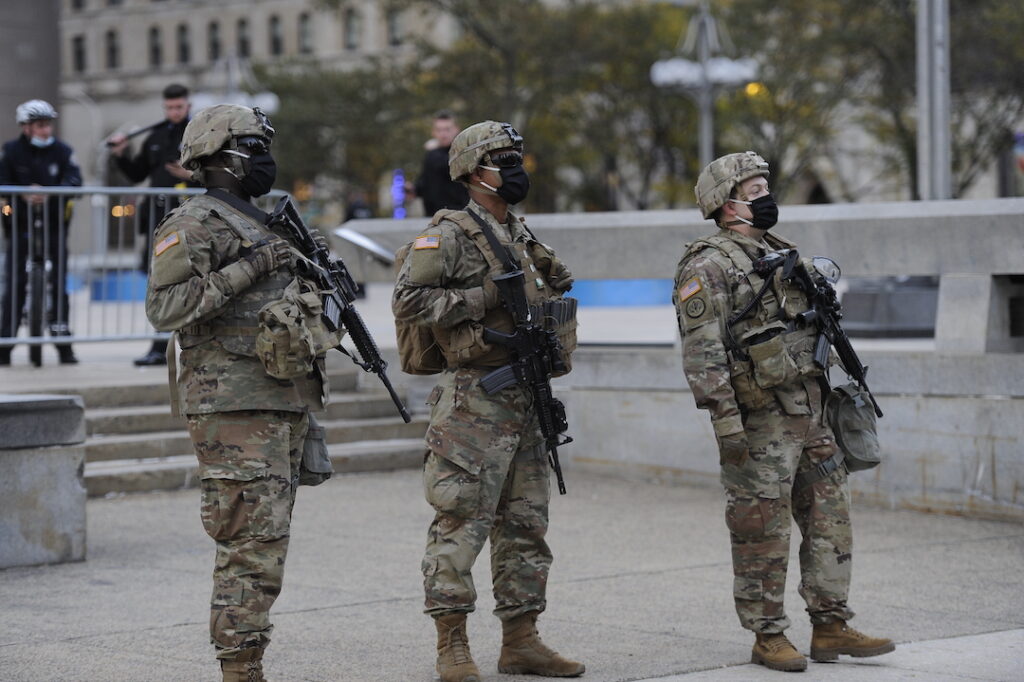 Philadelphia President Trump has threatened to send federal troops to crime-ridden cities. Could Philadelphia be next? Here, a photo of the Pennsylvania National Guard stand watch near City Hall in 2020. (AP Photo/Michael Perez)