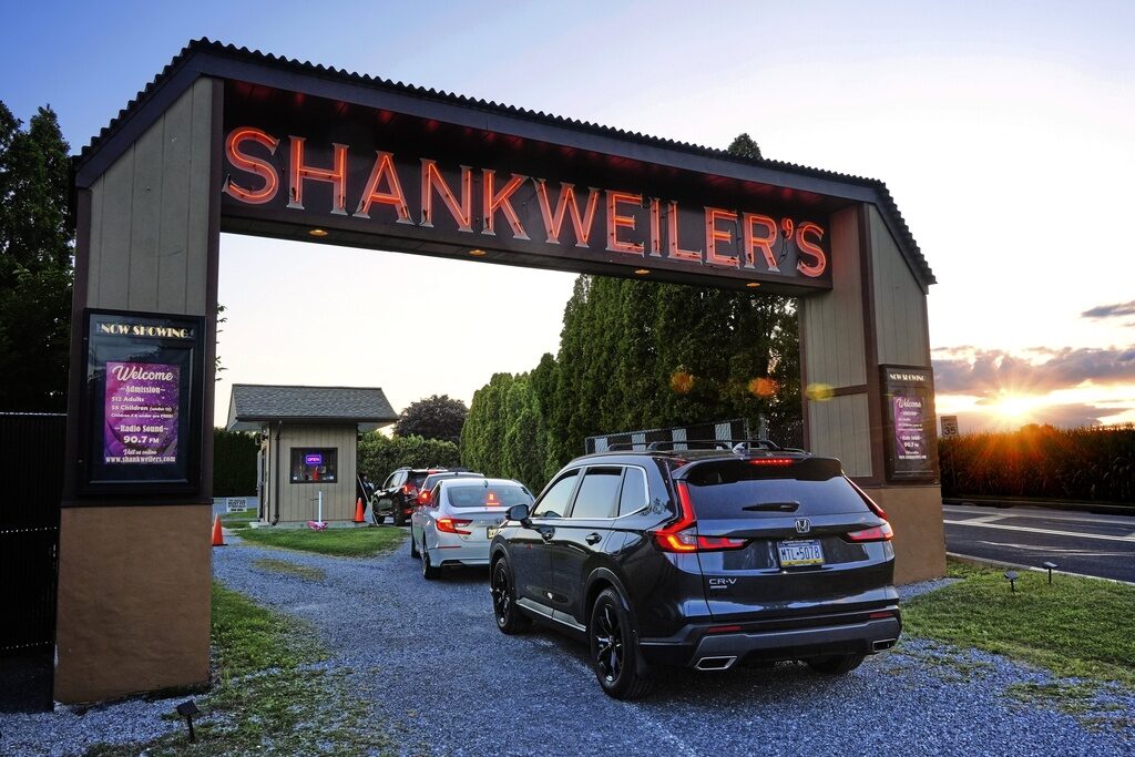 The entryway to a drive-in theater where an archway has the word "Shankweiler's" in glowing letters
