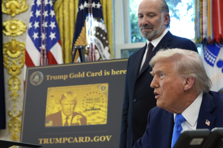 President Donald Trump speaks as Commerce Secretary Howard Lutnick listens in the Oval Office of the White House