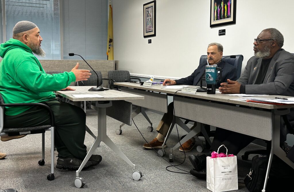 Faheem Lea addressing State Board of Education member Jack Fornaro and Board Vice President Nedd James Johnson with his concerns about the Camden City School District during public testimony