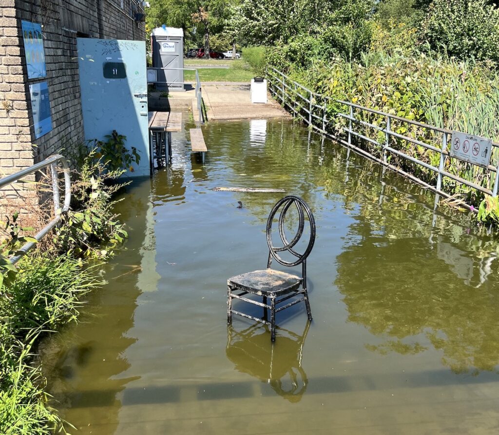 Chair outside flooded boathouse