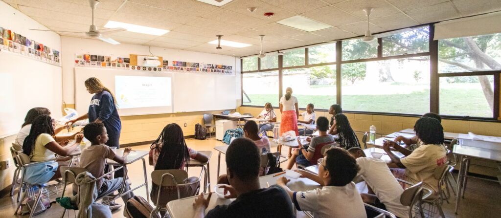 A Breakthrough teacher instructs a group of teaching fellows.