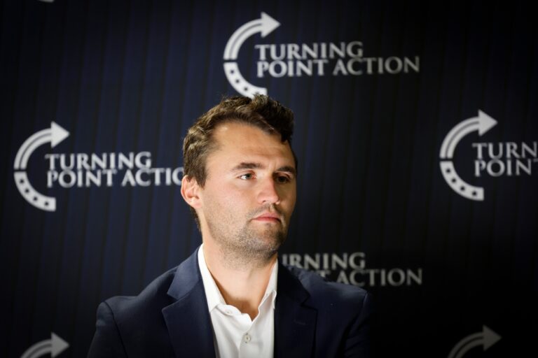Charlie Kirk looks on