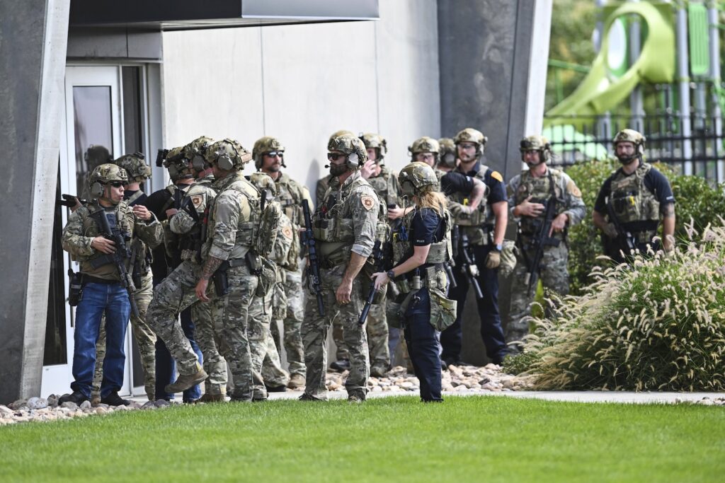 APTOPIX Charlie Kirk Shot Law enforcement officials prepare to sweep a building
