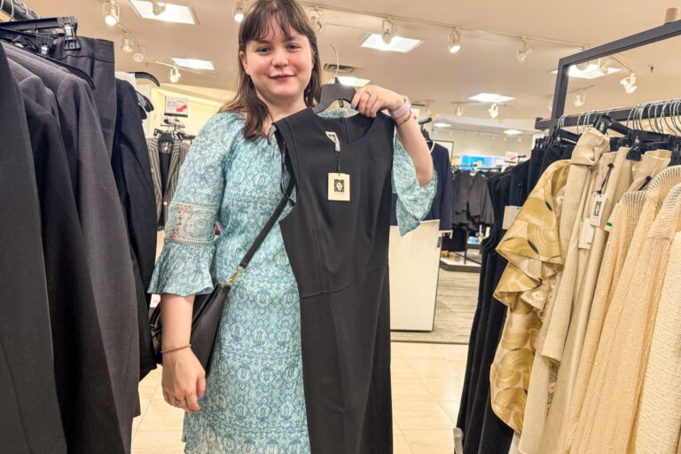 Sarah Bailey holds up a dress