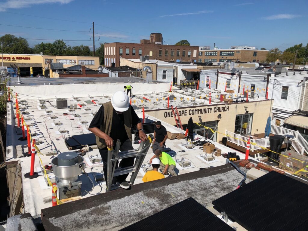 hunting-park-solar-one-hope-community-church-allen-drew-092925-01 Solar installers set up an array on the roof of One Hope Community Church in Hunting Park.