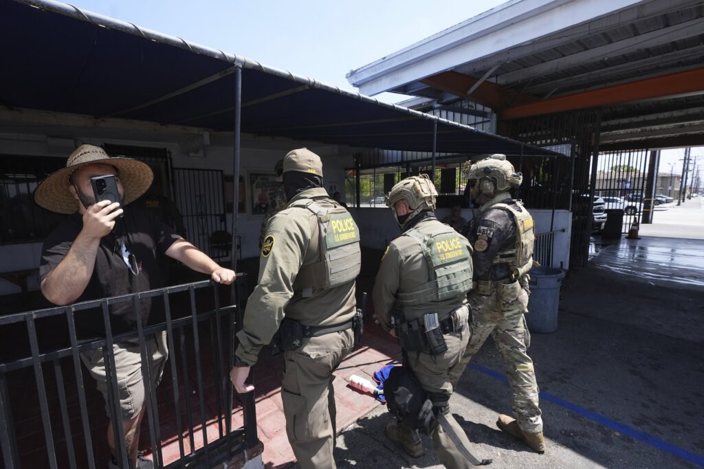 Immigration agents conduct an operation at a car wash