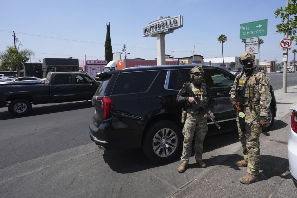 Immigration agents conduct an operation at a car wash